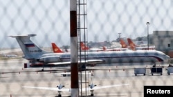 An airplane with the Russian flag is seen at Simon Bolivar International Airport in Caracas, Venezuela, March 24, 2019.