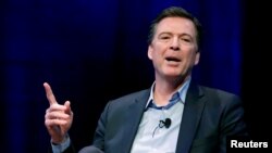 FILE - Former FBI director James Comey speaks during an interview at George Washington University in Washington, April 30, 2018. 
