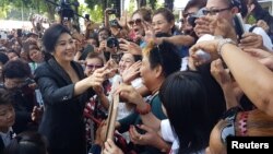 FILE - Ousted former Thai Prime Minister Yingluck Shinawatra greets supporters as she leaves the Supreme Court in Bangkok, Thailand, Aug. 1, 2017. 