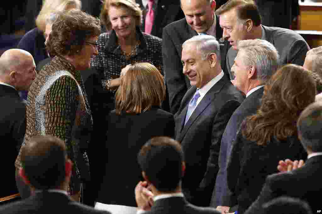 Israeli Prime Minister Benjamin Netanyahu, accompanied by House Majority Leader Kevin McCarthy of California, is greeted as he walks down the aisle before addressing a joint meeting of Congress on Capitol Hill in Washington, March 3, 2015.
