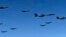 In this photo provided by South Korea Defense Ministry, U.S. Air Force B-1B bombers, F-35B stealth fighter jets and South Korean F-15K fighter jets fly over the Korean Peninsula during a joint drill on Sept. 18, 2017.