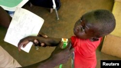 FILE - A Congolese boy has his arm measured for malnutrition in a clinic run by medical charity Medecins Sans Frontieres in the remote town of Dubie in Congo's southeastern Katanga province, March 18, 2006. 