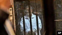 A mourner prays for the victims of the sunken ferry Sewol outside a temporary memorial altar in Seoul, April 16, 2015.