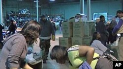 Volunteers sorting items donated for Haiti at a Washington warehouse