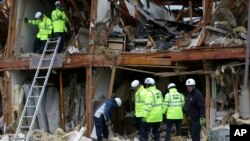 Firefighter conduct a search and rescue operation at an apartment destroyed by an explosion at a fertilizer plant in West, Texas, April 18, 2013. 