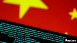 In this file illustration photo, computer code is seen on a screen above a Chinese flag. Image created on July 12, 2017. (REUTERS/Thomas White/Illustration/File Photo/File Photo)