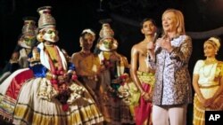U.S. Secretary of State Hillary Rodham Clinton, second right, shows appreciation after watching a performance by the Indian classical dancers at Kalakshetra in Chennai, India, July 20, 2011