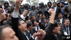 FILE - Lawyers supporting the Bangladesh Nationalist Party shout slogans outside a court against a verdict against former Prime Minister Khaleda Zia in Dhaka, Feb. 8, 2018. 