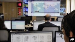 Interpol employee looks at finger prints in the control room of the Interpol headquarters in Lyon, central France, file photo. 