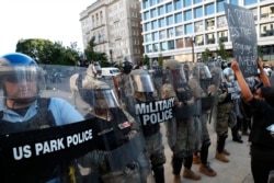 FILE - Police clear the area around Lafayette Park and the White House as demonstrators gather to protest the death of George Floyd, June 1, 2020, in Washington. Floyd died after being restrained by Minneapolis police officers.