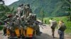 FILE - M23 rebels withdraw from the Masisi and Sake areas in eastern Congo, Nov 30, 2012.