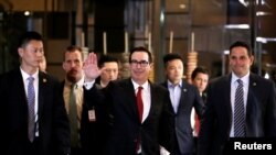 U.S. Treasury Secretary Steven Mnuchin, a member of the U.S. trade delegation to China, waves to the media as he returns to a hotel in Beijing, China, May 3, 2018.