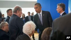 President Barack Obama and Argentine President Mauricio Macri greet guests in the audience after their joint statement during their visit to Parque de la Memoria (Remembrance Park) in Buenos Aires, Argentina, March 24, 2016. 
