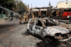 Fire fighters douse a fire at Gokul puri tire market which was burnt Tuesday in New Delhi, India, Feb. 26, 2020.
