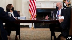 President Joe Biden speaks with Vice President Kamala Harris about the southern border during a meeting in the State Dining Room of the White House, March 24, 2021.