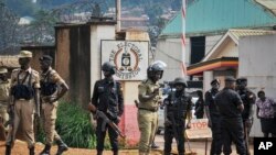 FILE - Security forces surround the entrance to the Electoral Commission as Ugandan presidential hopeful and political activist Bobi Wine, whose real name is Kyagulanyi Ssentamu, meets with them in Kampala, Uganda, Jan. 9, 2020. 