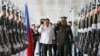 Philippine President Rodrigo Duterte, center left, salutes the troops with Armed Forces Chief Gen. Ricardo Visaya before boarding his flight for a three-day official visit to Japan at the Ninoy Aquino International Airport in suburban Pasay city, south of Manila, Philippines, Tuesday, Oct. 25, 2016.