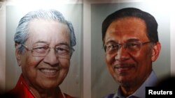 Malaysia's Prime Minister designate and former interior minister Muhyiddin Yassin waves to reporters before his inauguration as the eighth prime minister, in Kuala Lumpur, Malaysia, March 1, 2020. 