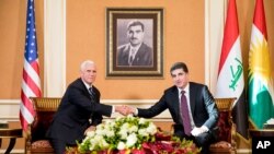 U.S. Vice President Mike Pence, left, and President of Iraq's Kurdistan region Nechirvan Barzani, shake hands during a bilateral meeting at Erbil International Airport, in Erbil, Iraq, Nov. 23, 2019. 