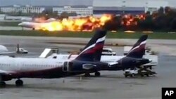 This image taken from video provided by Instagram user @artempetrovich, shows the SSJ-100 aircraft of Aeroflot Airlines on fire during an emergency landing in Sheremetyevo airport in Moscow, Russia, May 5, 2019. 