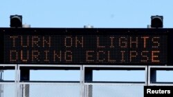 A sign on the highway refers to the upcoming solar eclipse near Guernsey, Wyoming, Aug. 19, 2017. 