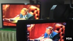 នៅ​ក្នុង​រូប​ថត​ពី​អេក្រង់​ទូរទស្សន៍​នៅ​មន្ទីរ​ដ្ឋសភា​នេះ លោក ហេង សំរិន ប្រធាន​រដ្ឋសភា​ជាតិ​​​ នៅ​ក្នុង​សម័យ​ប្រជុំ​អនុម័ត​ច្បាប់​អង្គការ​កាល​ពី​ថ្ងៃ​ច័ន្ទ​ ទី​១៣ ខែ​កក្កដា ឆ្នាំ​២០១៥។ (នៅ វណ្ណារិន/VOA) 