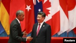 U.S. President Barack Obama and Chinese President Xi Jinping speak during the G20 Summit in Hangzhou, September 4, 2016. 