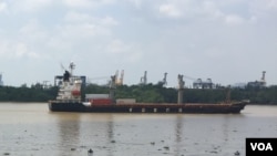 A container ship moves along the Saigon River, used to ship the kinds of exports that have increased Vietnam’s role in global trade.