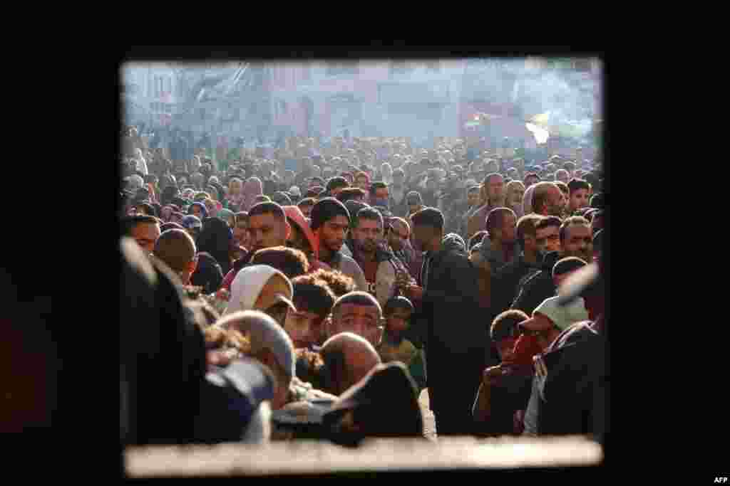 A huge crowd queues outside a bakery for fresh bread in the southern Gaza city of Khan Yunis, amid the continuing war between Israel and the Palestinian militant group Hamas.