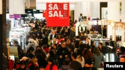 Shoppers are seen inside the Selfridges store on Oxford Street during the Boxing Day sales in central London, Britain December 26, 2018. 