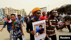 Sudanese take part in a march against the Rapid Support Forces, whom they blame for a raid on protesters who had camped outside the defense ministry during the 2019 revolution, in Khartoum, Sudan, June 3, 2021. 