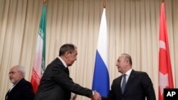 Menlu Rusia Sergey Lavrov (kiri) berjabat tangan dengan Menlu Turki Mevlut Cavusoglu di Moskow, Rusia, 20 Desember 2016. (AP Photo/Pavel Golovkin) 