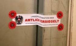 The seal with the inscription "State police department of Vienna, officially sealed" is pictured on a replacement door of a terrorist's apartment in Vienna, Austria, Nov. 4, 2020. Police blew up the original door.
