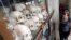 Tourists visit a memorial with the skulls of more than 8,000 victims of the Khmer Rouge regime located on outskirts of Phnom Penh, Cambodia, Oct. 16, 2013. 