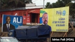 FILE - The election campaign posters of incumbent Gabonese President Ali Bongo and his rival Jean Ping of the opposition are side by side in Libreville, Aug. 26, 2016.