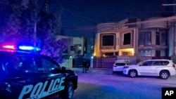 Security forces stand guard at the assassination scene of Hisham al-Hashimi, in Zeyouneh area, Baghdad, Iraq, July, 7, 2020. 