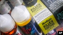 Flavored vaping solutions are shown in a window display at a vape and smoke shop, in New York. 