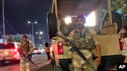 Iraqi security forces stand guard near the Bahraini Embassy in Baghdad, Iraq, June 27, 2019. Demonstrators were protesting a conference aimed at promoting Arab-Israeli peace.