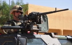 FILE - French troops patrol in the streets of Gao on Feb. 3, 2013 as France jets carried out major air strikes near Kidal.