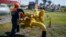 FILE - A worker turns a valve at an underground gas storage facility near Striy, Ukraine, May 21, 2014.