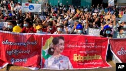 ក្រុមបាតុករ លើក​ម្រាមដៃ​បី​ដែល​ជានិមិត្តរូប​នៃ​ការតស៊ូ​នៅ​ផ្លូវ​ប្រសព្វ​មួយ​ក្នុង​ទីក្រុង​រ៉ង់ហ្គូន​នៃ​ប្រទេស​មីយ៉ាន់ម៉ា នៅ​ថ្ងៃពុធ ទី១០ ខែកុម្ភៈ ឆ្នាំ២០២១។