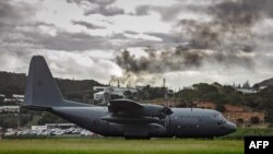 A Royal New Zealand Air Force C-130 Hercules aircraft lands to evacuate people at the airport in Noumea, New Caledonia, on May 21, 2024. (Australian Department of Defense via AFP)