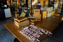 Employees are seen packing items inside Chu Chocolate Bar & Cafe, a day after it permanently closed, in Bangkok, Thailand, June 1, 2021.