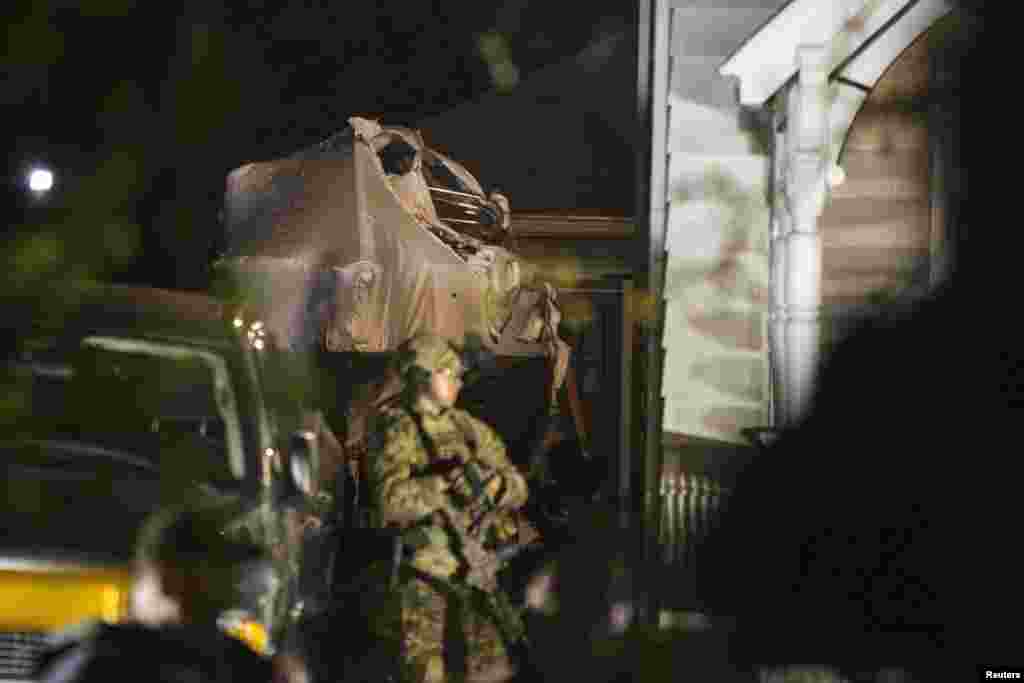 An FBI officer stands in front of the boat at 67 Franklin St., where Dzhokhar Tsarnaev, the surviving suspect in the Boston Marathon bombings, was hiding inside in Watertown, April 19, 2013.