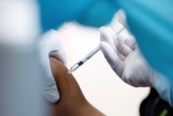 FILE - A medical worker receives AstraZeneca's COVISHIELD coronavirus disease (COVID-19) vaccine in Yangon, Myanmar, Jan. 27, 2021.