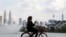 A woman rides a bicycle at a park, amid the coronavirus disease (COVID-19) pandemic, in Kuala Lumpur, Malaysia, Sept. 27, 2021. 