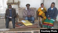 Somanje-Makata (second from left) sits at court in his Blantyre suburb with court advisers. (Photo by Lameck Masina)