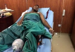 FILE - A victim of a gunshot wound sustained in the crackdown on Sudanese protesters is seen inside a ward receiving treatment in a hospital in Khartoum, Sudan, June 7, 2019.