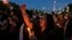 FILE - Activists hold a vigil for a teenage girl who was raped and murdered, in Jakarta, Indonesia, May 4, 2016.