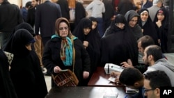 Iranians queue for voting in the parliamentary elections in a polling station in Tehran, Iran, Feb. 21, 2020. 